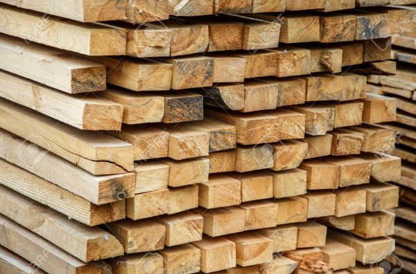 Wood timber construction material for background and texture. Wooden boards in a warehouse of building materials.